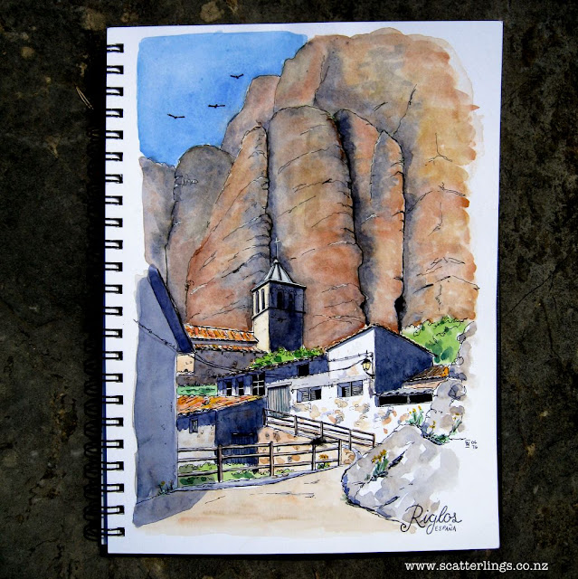 The town of Riglos is dwarfed by the large conglomerate towers behind and home to many vultures.