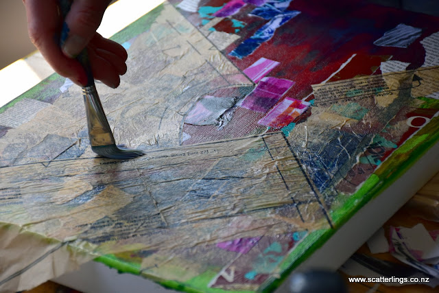 Heidi adding collage papers at the beginning of a mixed media piece