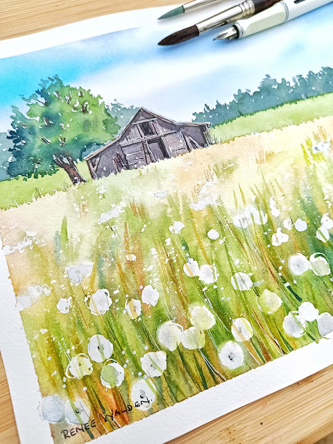 a barn in a field of dandelions