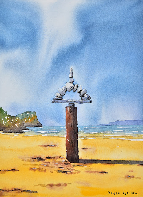 a rock sculpture on the beach